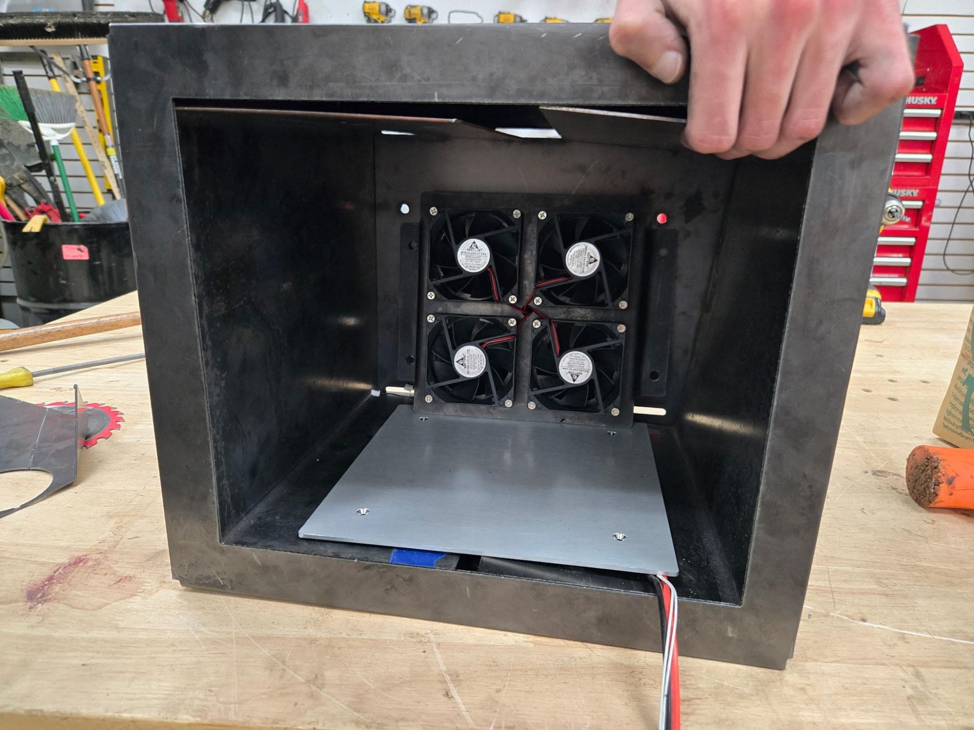 ECOFIL dehydrator chamber opened to show the internal brushless-fan array and shelf