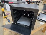 Built black powder-coated ECOFIL dehydrator chamber with the front open showing the internal fan array