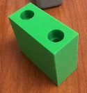 Close-up of a printed block whose two guide-rod holes came out undersized