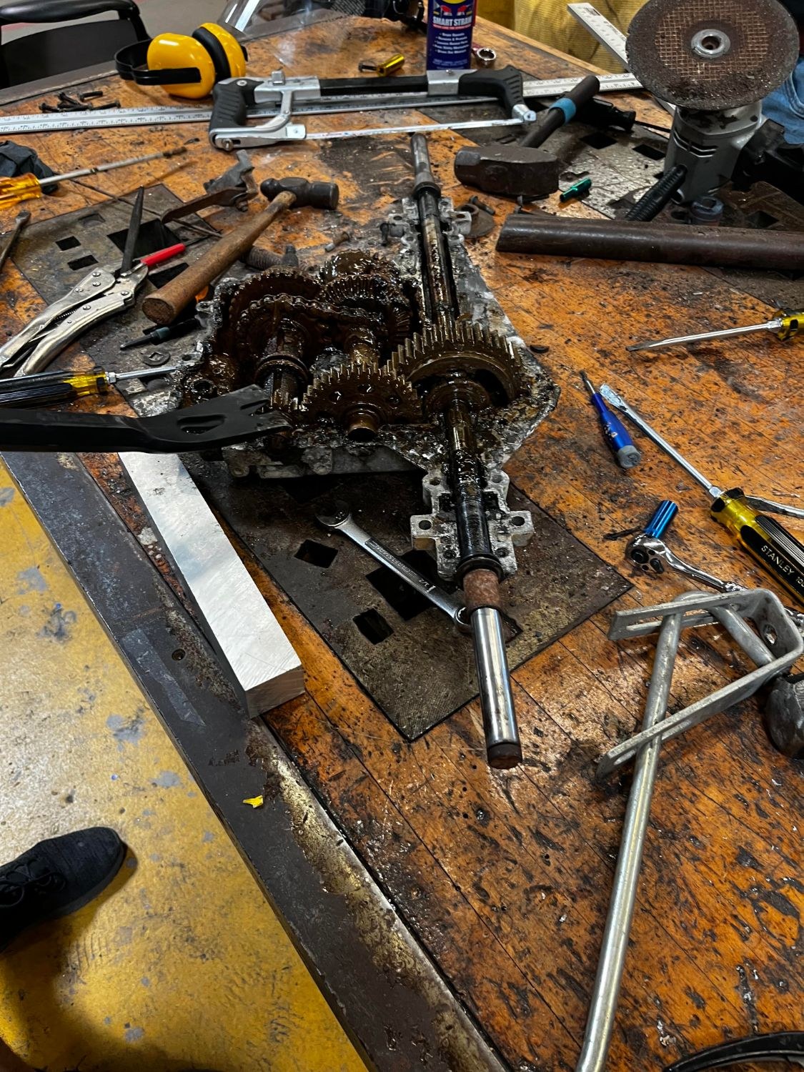Disassembled gas transaxle showing gears, shafts, and chain