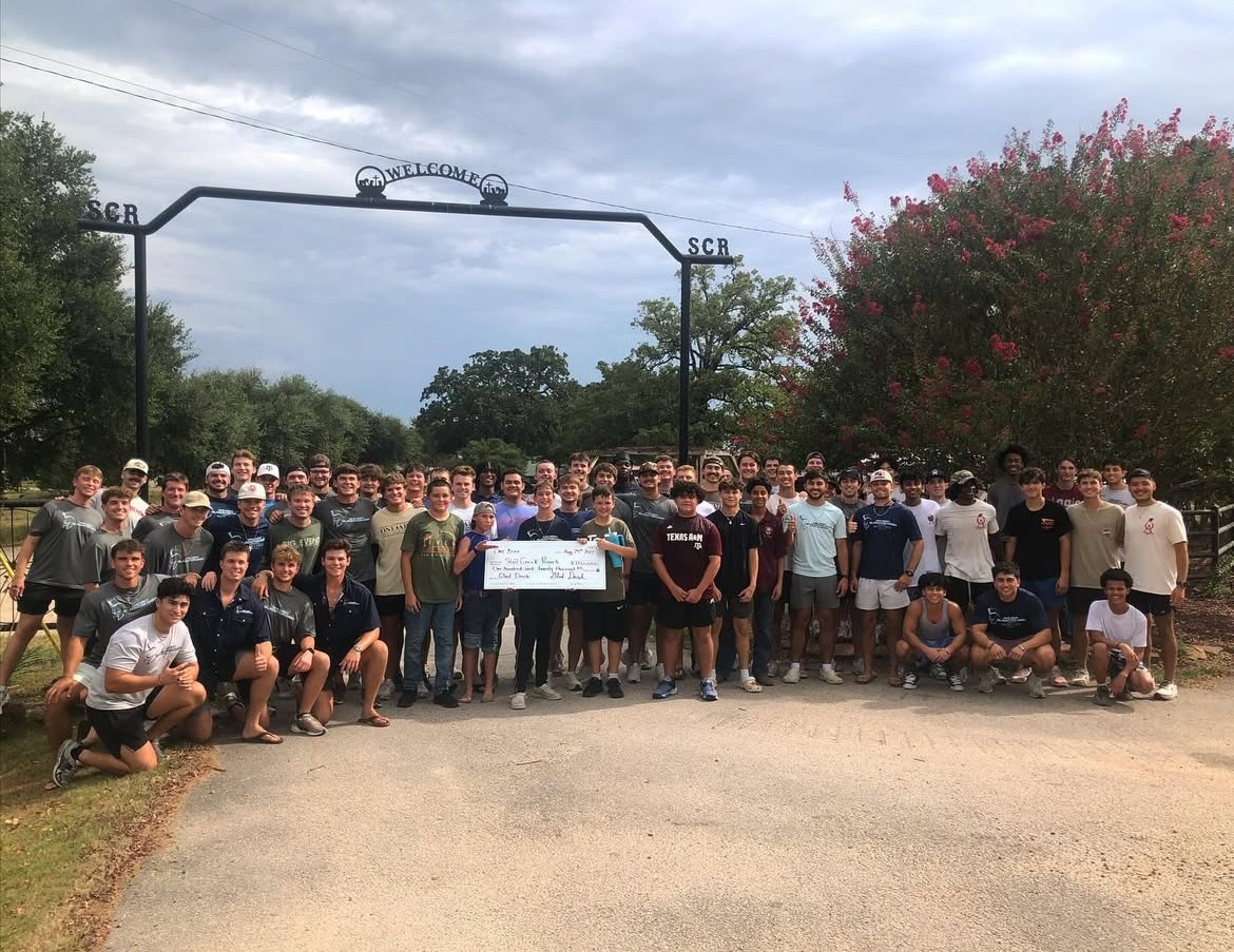 One Army members presenting a donation check to Still Creek Ranch at the ranch gate